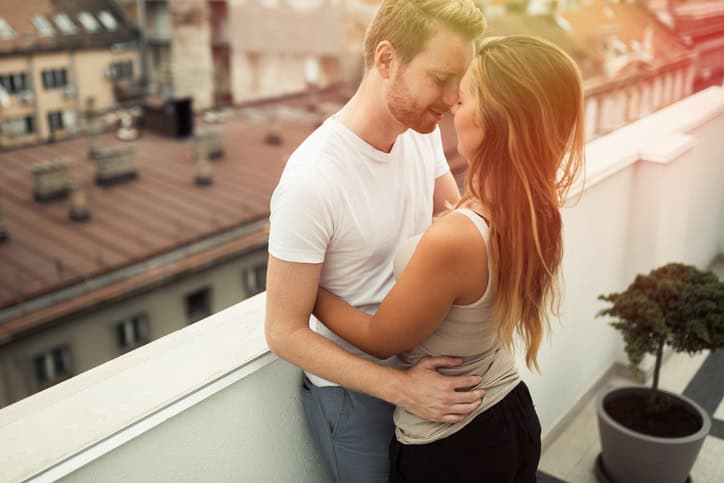 Couple hugging on rooftop terrace and bonding