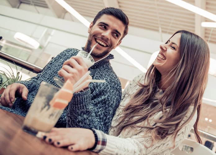 Beautiful loving couple flirting in a cafe