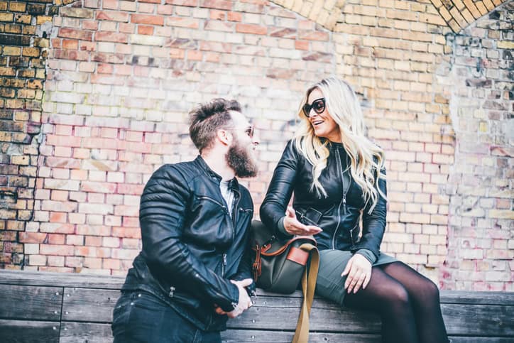 A modern couple sitting on the stair and talking