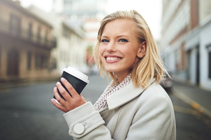 happy woman coffee city street