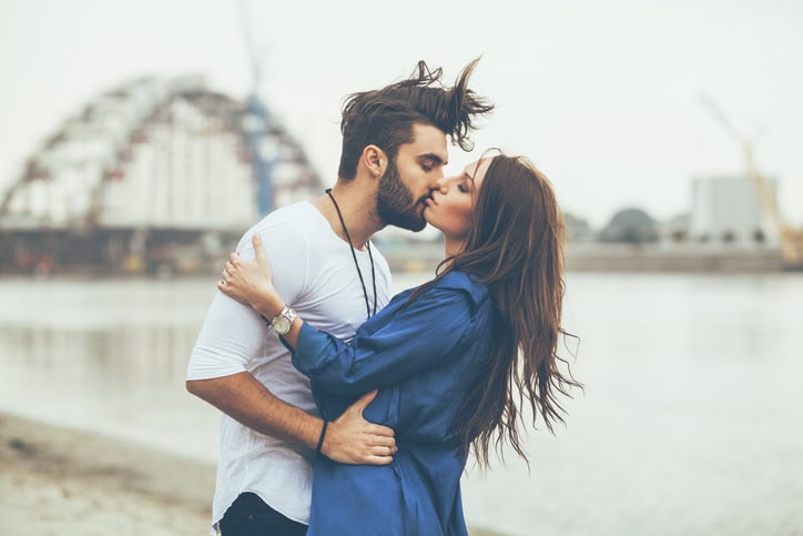 Young couple kissing by the river