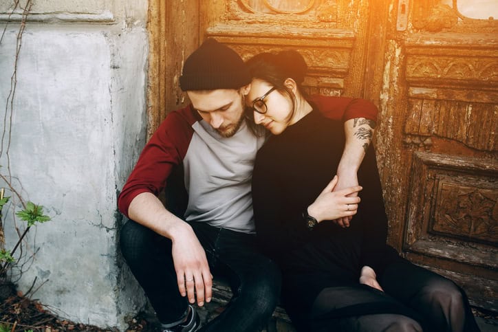 young beautiful couple posing on the background of an old building