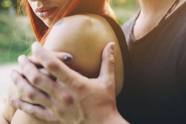 guy hugging his girlfriend from the back