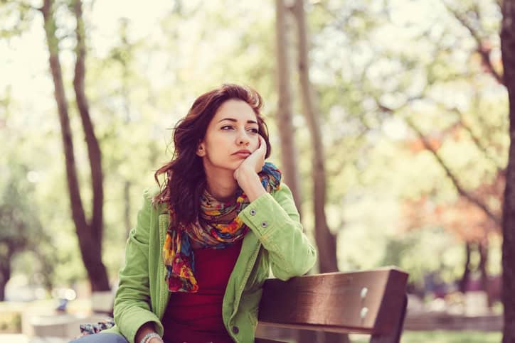 Thoughtful woman in the park
