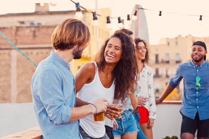 Multi ethnic happy friends havung fun at the rooftop party.