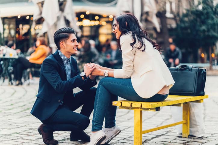 Young man asking his girlfriend to marry him