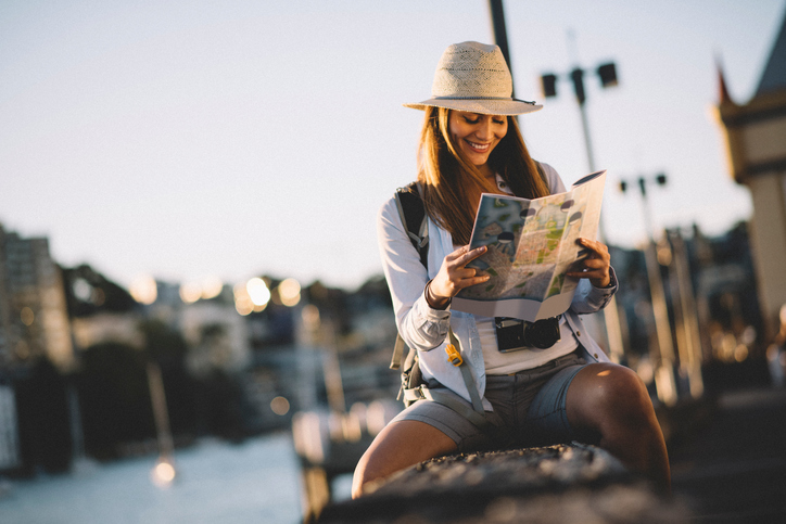 Tourist focusing on a city map in the street.