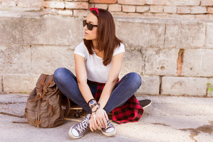 Girl sitting on the concrete