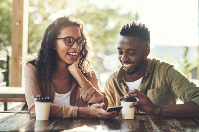couple looking at phone in cafe