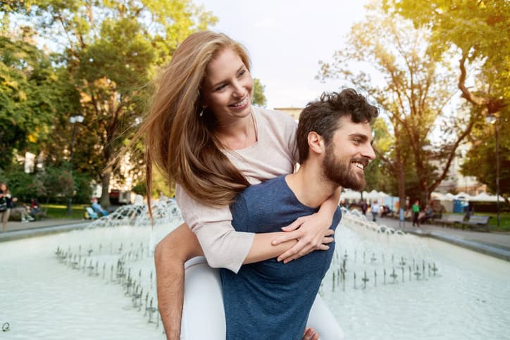 Young couple having fun together in park.