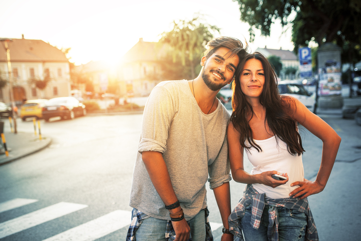 Happy young couple hangout and having fun at the city street.Sunset.