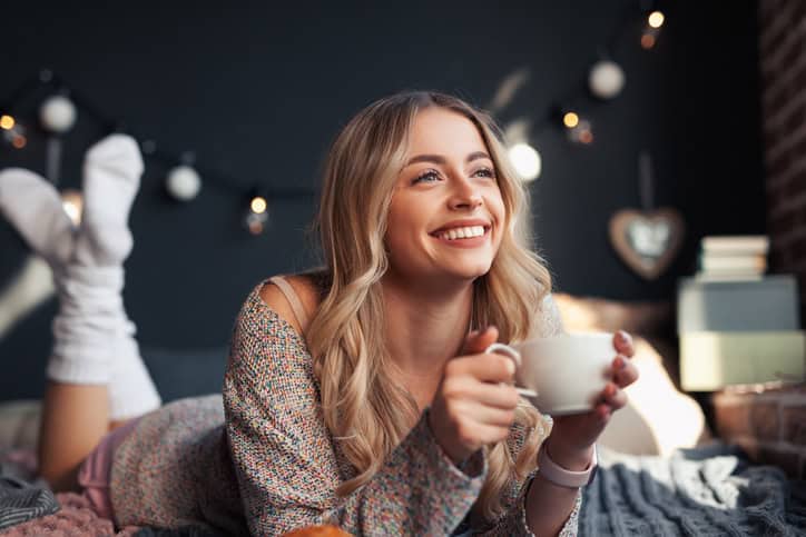 Cheerful woman having a coffee.