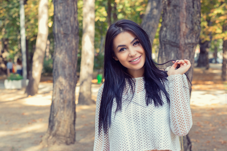A shot of a smiling confident Asian Indian woman outdoor