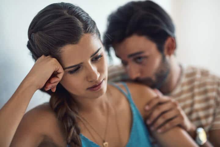 Shot of a young couple having an argument while sitting on their couch at home