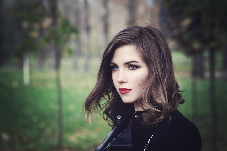 Beautiful Young Woman Fashion Model Walking in the Park. Outdoors Portrait