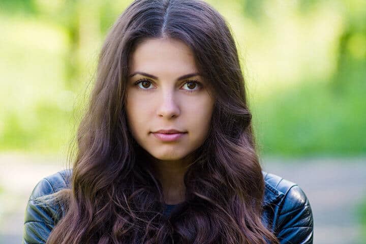 Portrait of a young beautiful girl in spring park on a sunny day