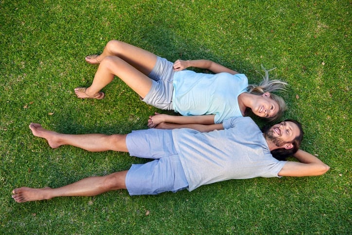 Couple laid on grass