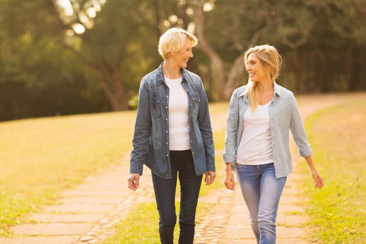 beautiful mother and daughter walking in the forest