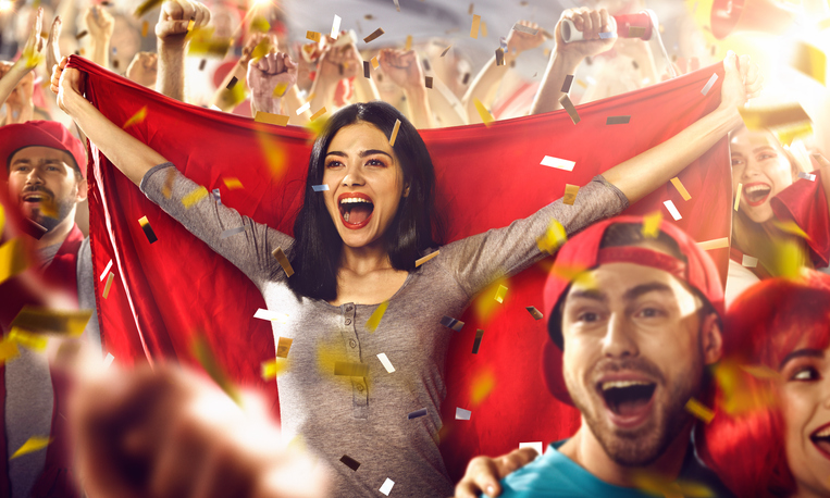 Sport fans: A girl holds a flag in her hands