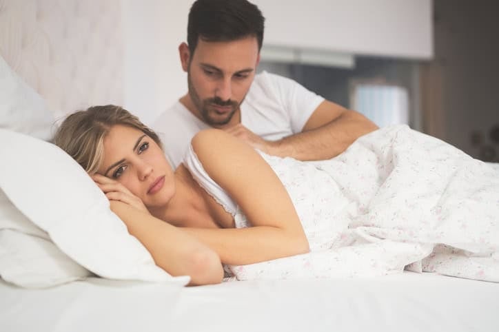 Relationship crisis in bed with feeling of guilt