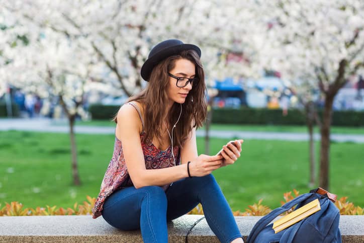 Woman text messaging in the park