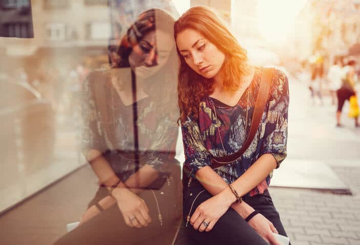 girl sad leaning against a window