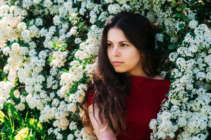 Girl in the Red Dress on a background of white color in the park