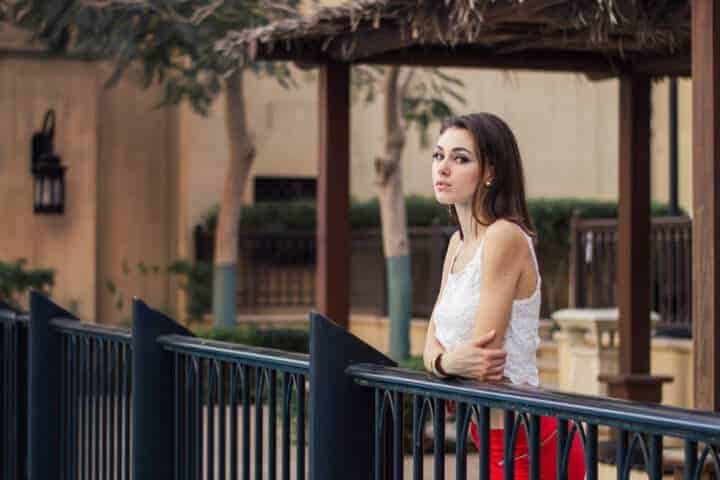 Young european female in white crop top and red skirt