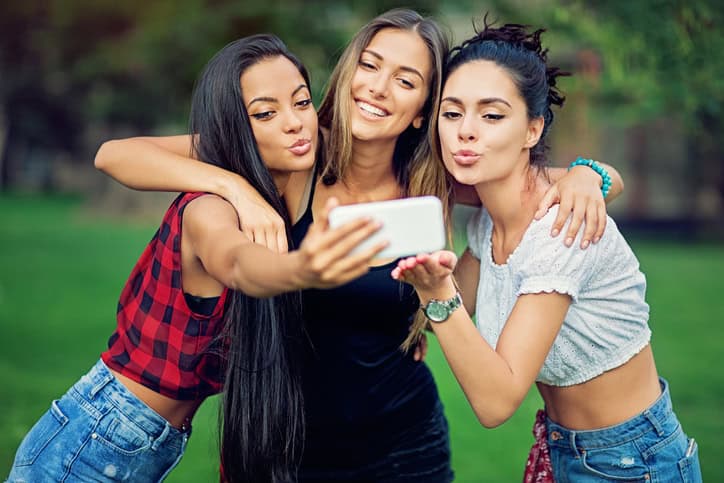 Happy three girlfriends taking a picture.