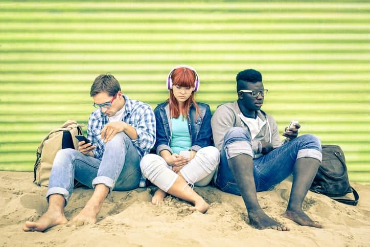 Group of young multiracial friends with smartphone and mutual di