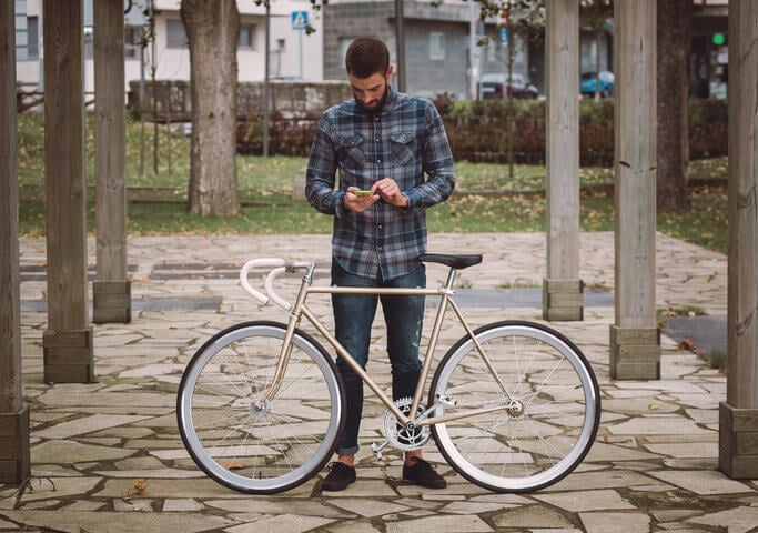 hipster man with bike on phone