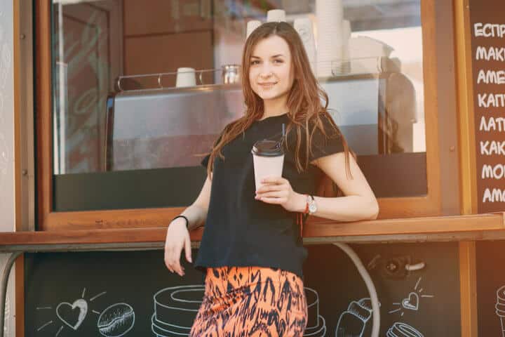 beautiful girl in the city with cup coffee