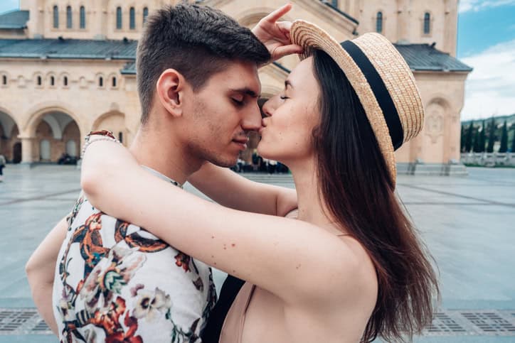 Young couple in love, hugging on the street. Selective focus.