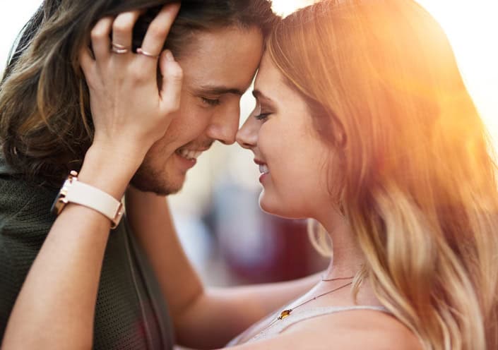 Shot of an affectionate young couple sharing a tender moment outdoors