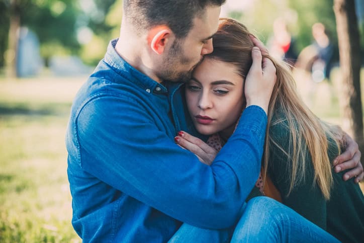 Unhappy young couple in the city park