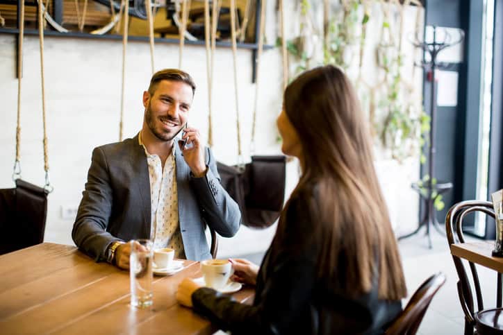 Young couple sitting in a cafe and talking