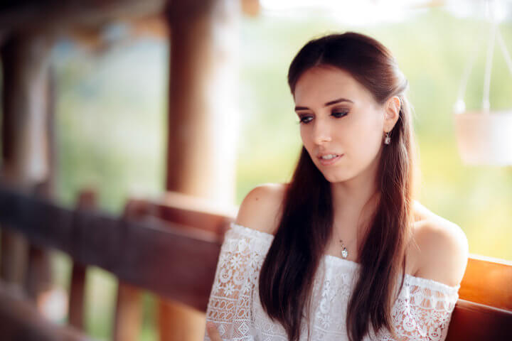 Romantic girl thinking about something sad