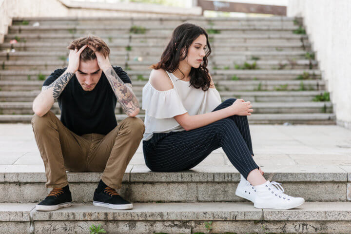 Young people with problems sitting at the staircase