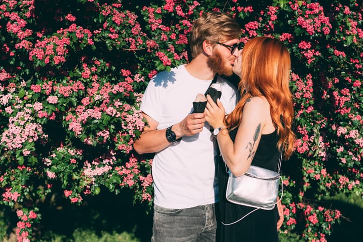 A young couple kissing.