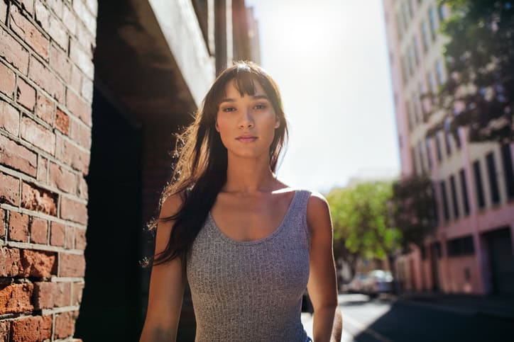 Young woman walking down the city street.
