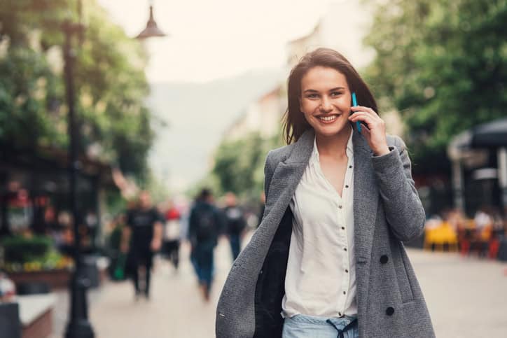 Woman talking on the phone outdoors in the city.
