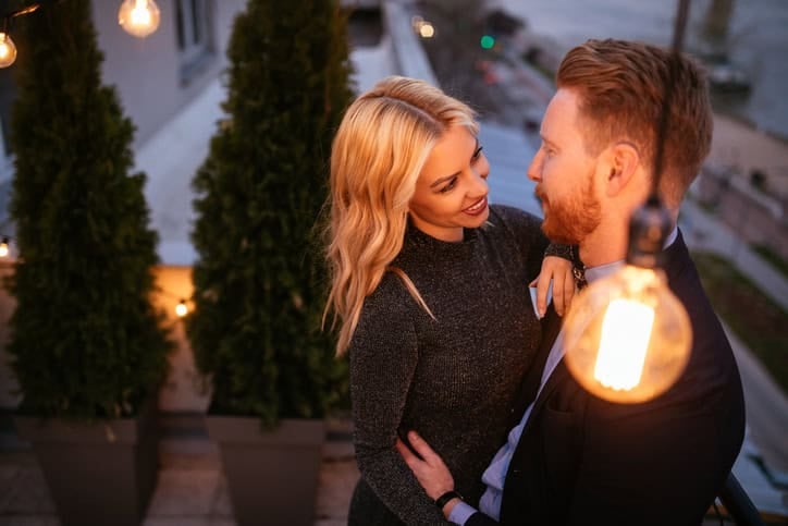 Portrait of a happy young couple enjoying spending time together on the balcony.