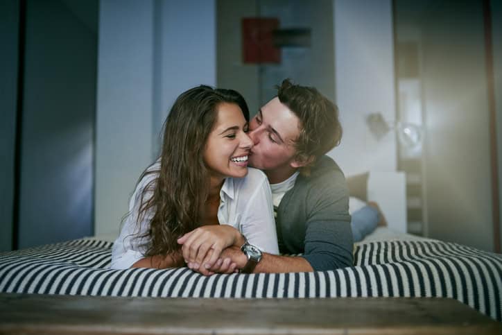 Shot of an affectionate young couple lying on bed