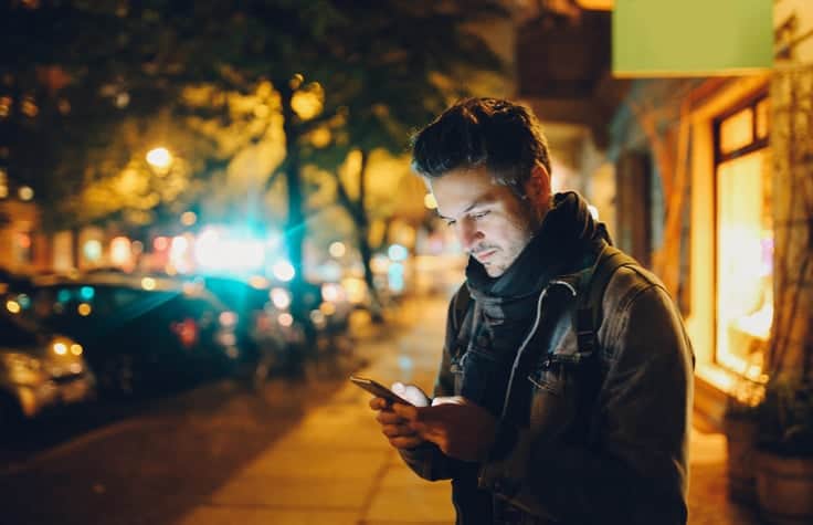 Young man texting in Berlin