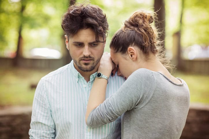 Girl crying on man's shoulder