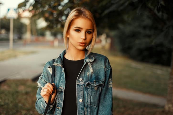 Beautiful young woman with clean skin in jeans clothes on a summer day