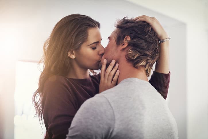 Shot of a young couple making out in the kitchen
