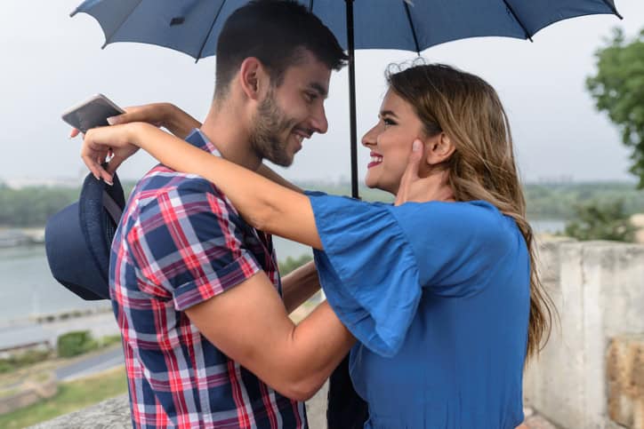Handsome couple under the umbrella