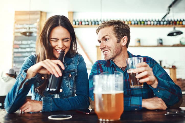 Shot of a young couple enjoying a drink at a bar