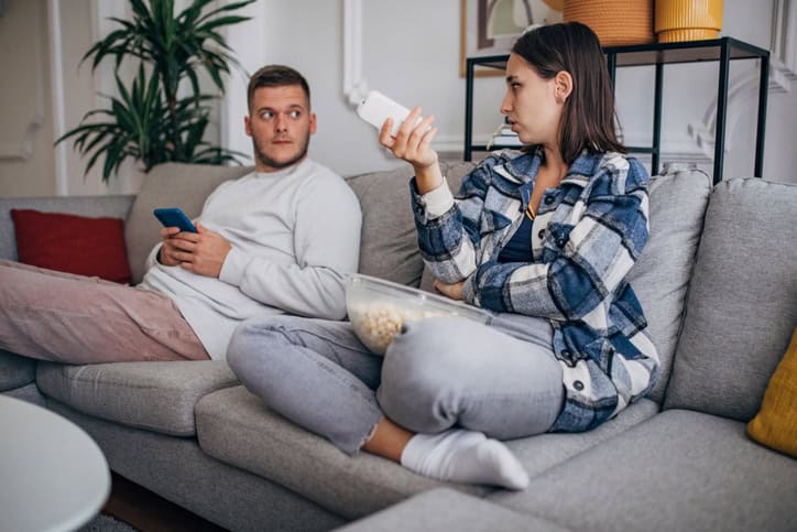 Unhappy couple sitting on couch.